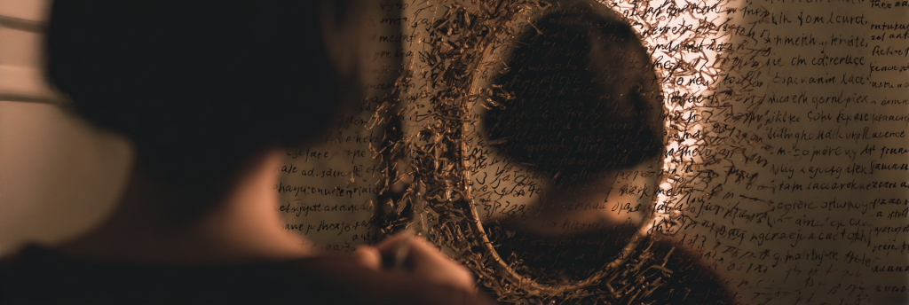 An older writer sits at a cluttered desk, surrounded by floating handwritten pages glowing in the dark. The light-filled pages drift through the air, suggesting a deep creative process connecting thought, voice, and revision.