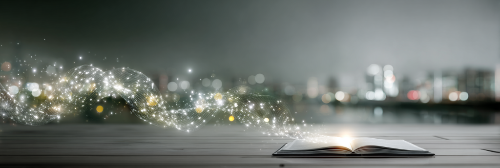 An open book on a wooden table with glowing strands of light rising into the air, sparkling against a blurred city skyline in the background